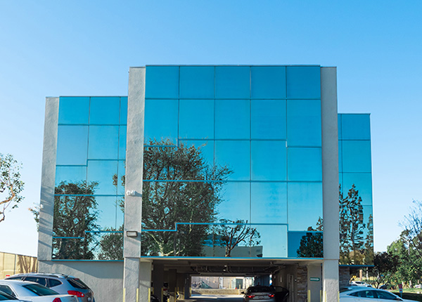 AmeriPharma glass building with parking lot AmeriPharma glass building with parking lot