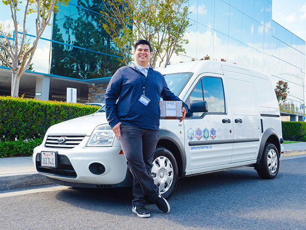 AmeriPharma driver and delivery van in front of AmeriPharma building AmeriPharma driver and delivery van in front of AmeriPharma building